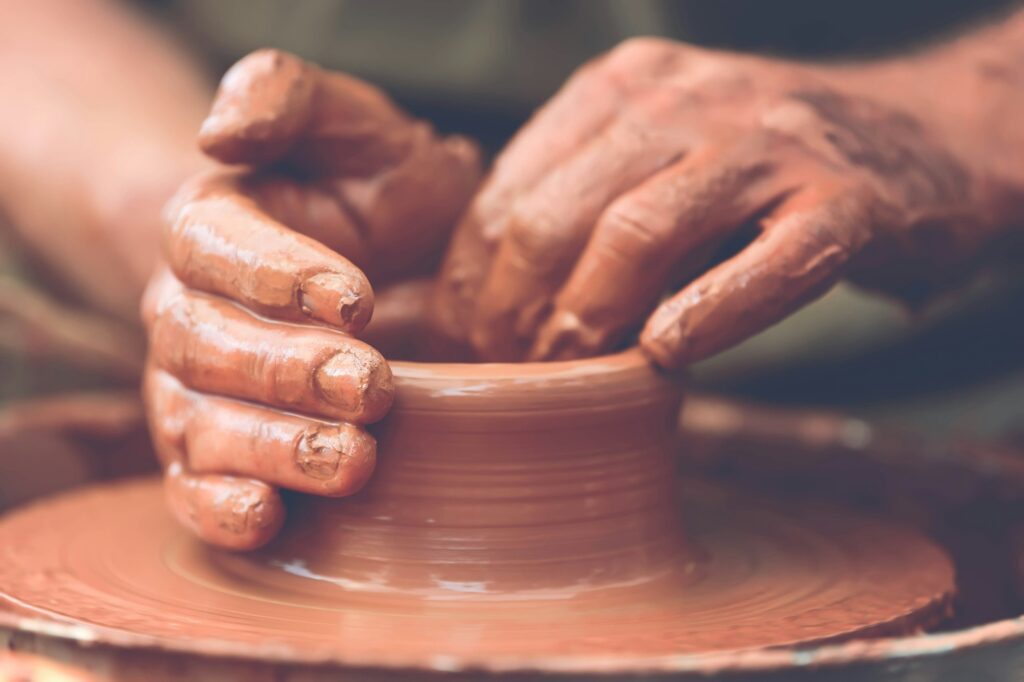 Potter making ceramic pot on the pottery wheel